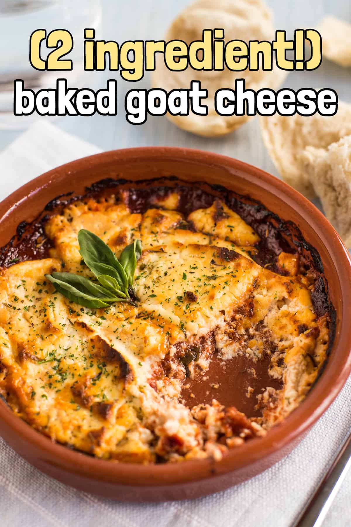 Baked goat's cheese in tomato sauce with a scoop removed