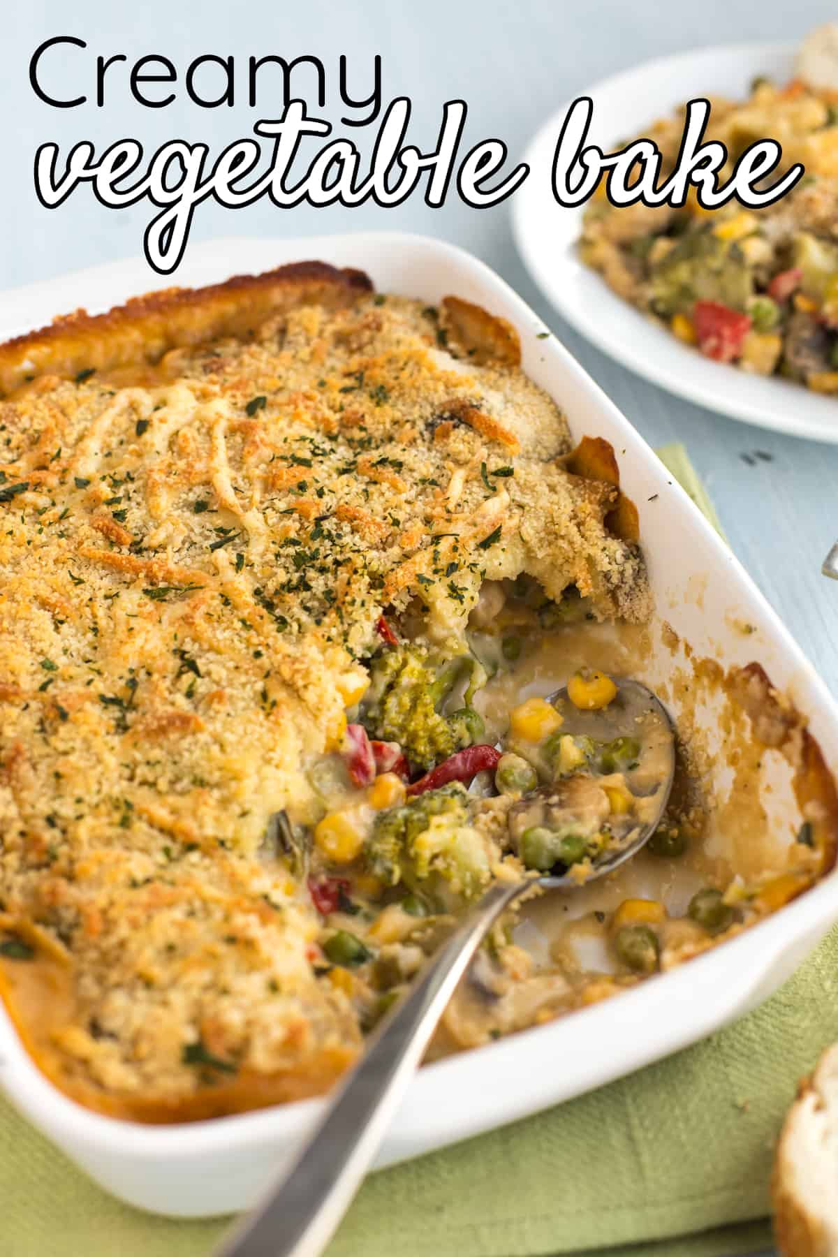 Creamy vegetable bake in a baking dish with a large spoonful removed.