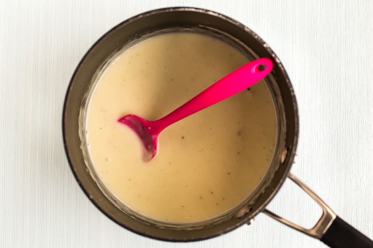 A simple white sauce in a saucepan.