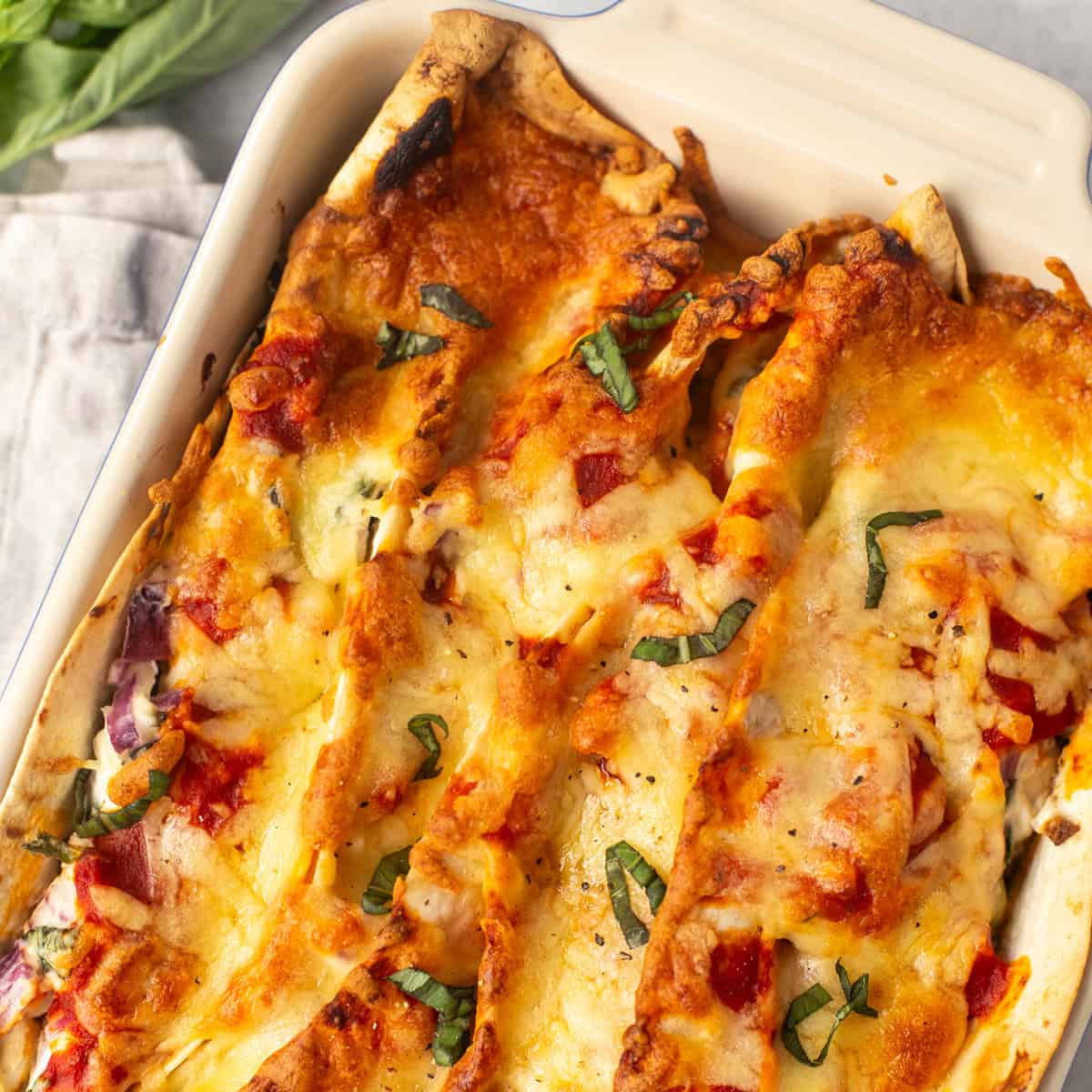 Overhead view of creamy zigzag tortilla bake in a dish.