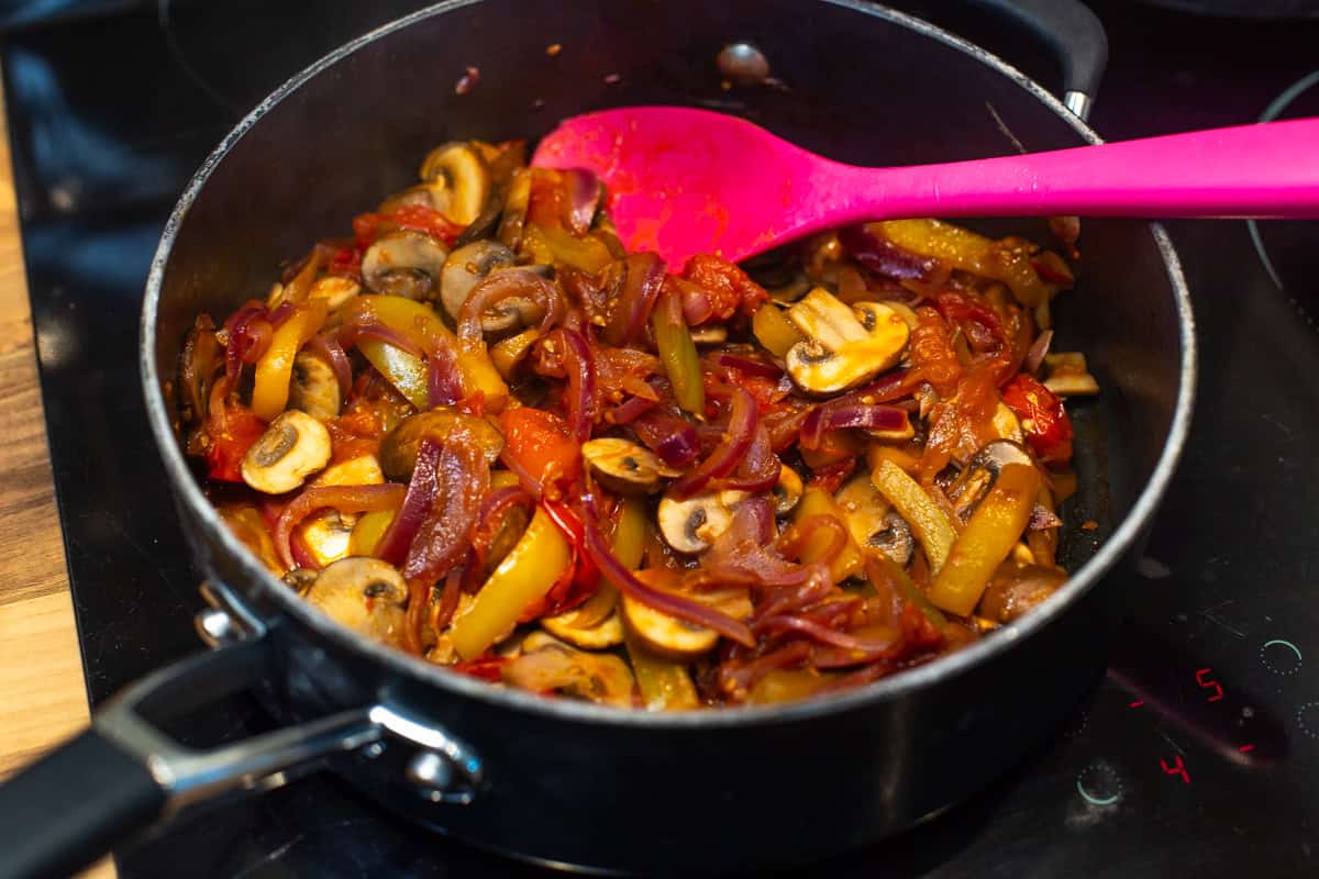 Mediterranean vegetables cooking in a frying pan.