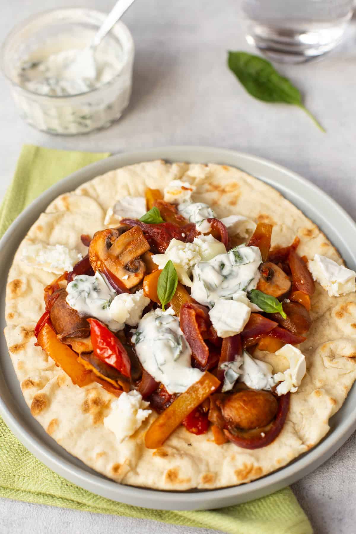 A soft chapatti topped with vegetables and goat cheese.