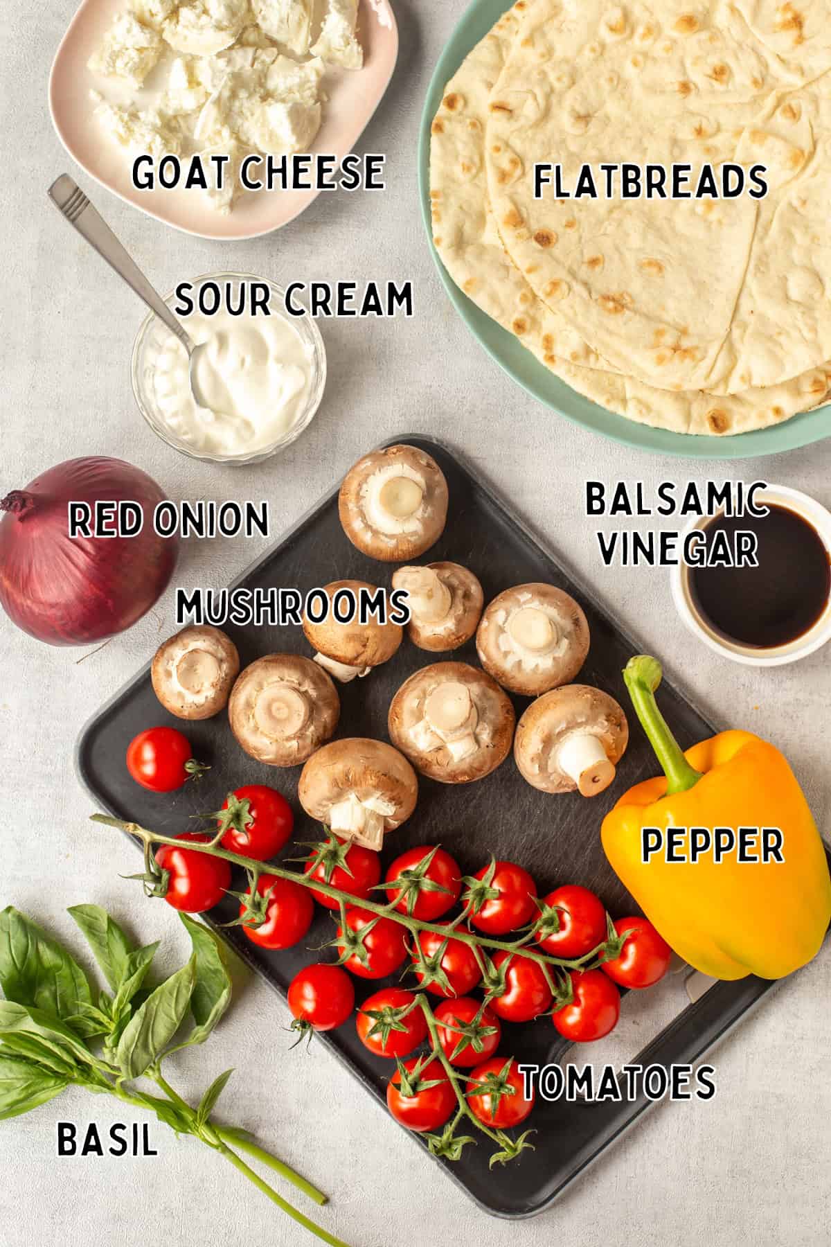 Ingredients for Mediterranean vegetable flatbreads laid out with text overlay.