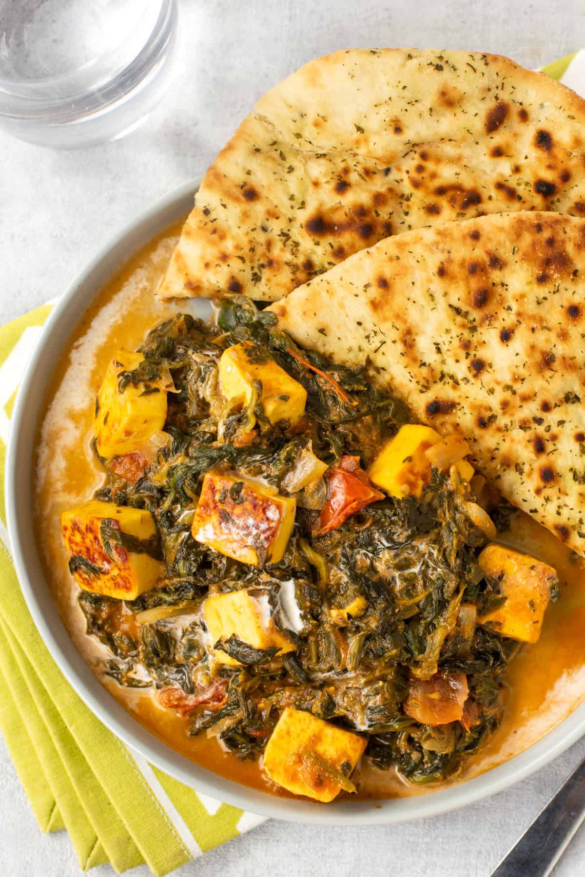 Creamy saag paneer with naan bread.