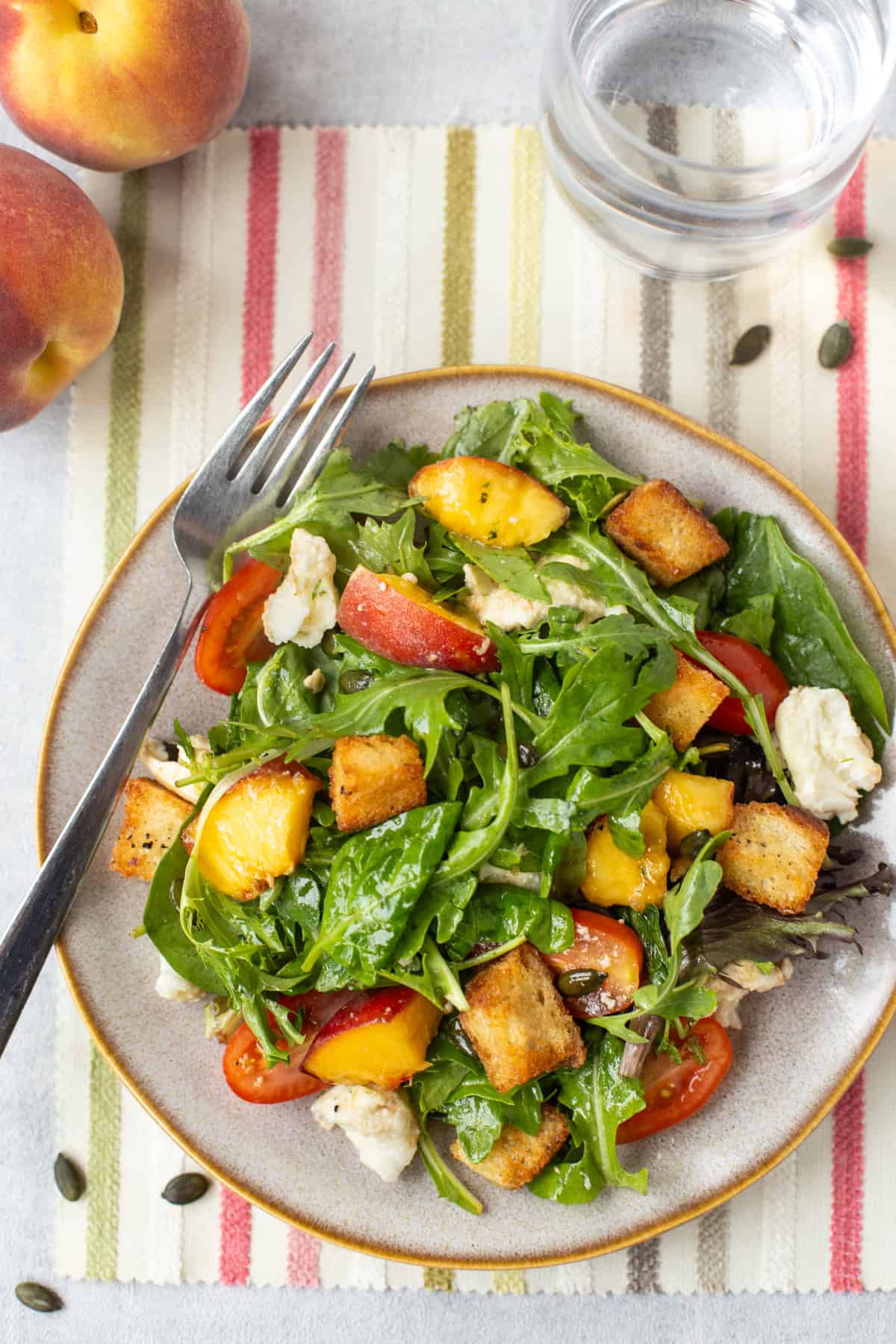 Mozzarella and peach salad with homemade croutons and tomatoes.