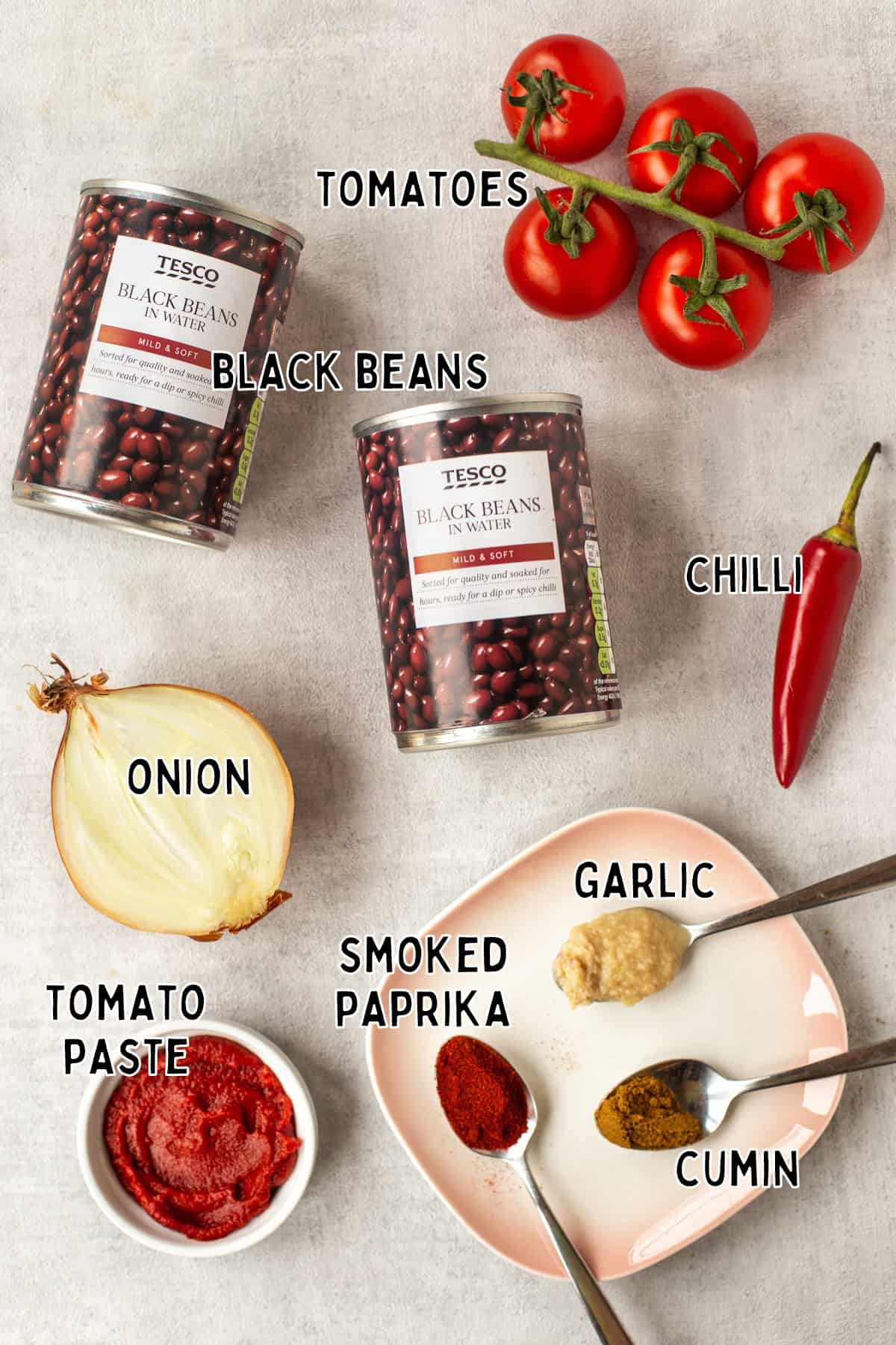 Ingredients for tomato and black bean stew laid out with text overlay.