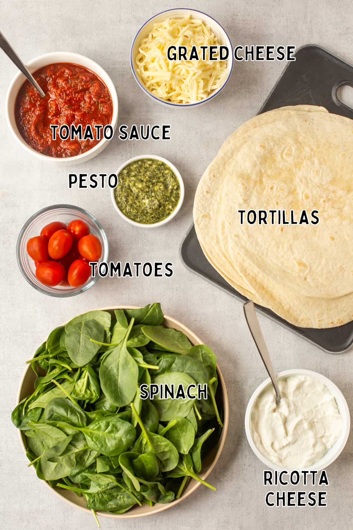 Ingredients for spinach and ricotta enchiladas laid out with text overlay.