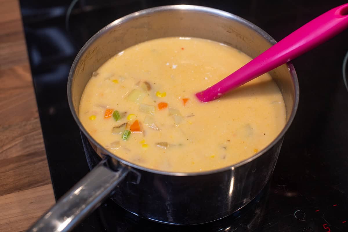 Vegetables and coconut milk in a saucepan.