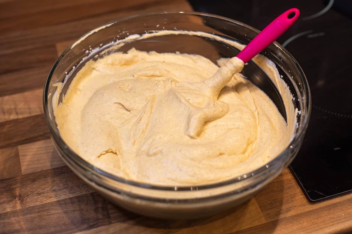 Unfrozen pumpkin pie ice cream mixture in a large bowl.