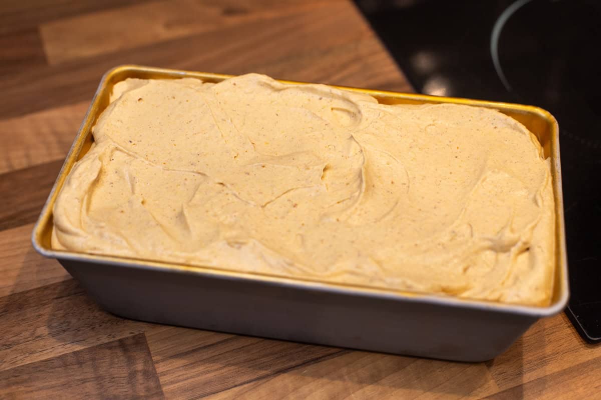 Unfrozen pumpkin ice cream in a loaf tin.