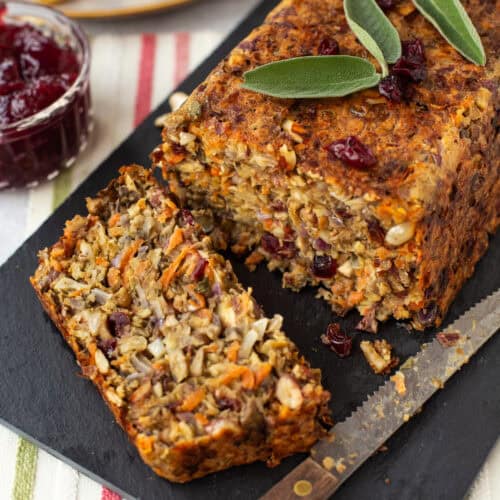 A vegetarian nut roast with a slice cut off.