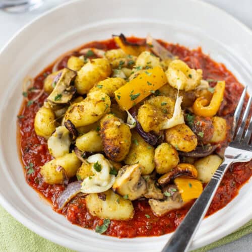 Air fryer gnocchi and vegetables on tomato sauce.