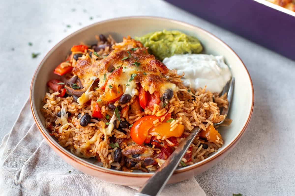 Cheesy baked rice with vegetables and black beans.