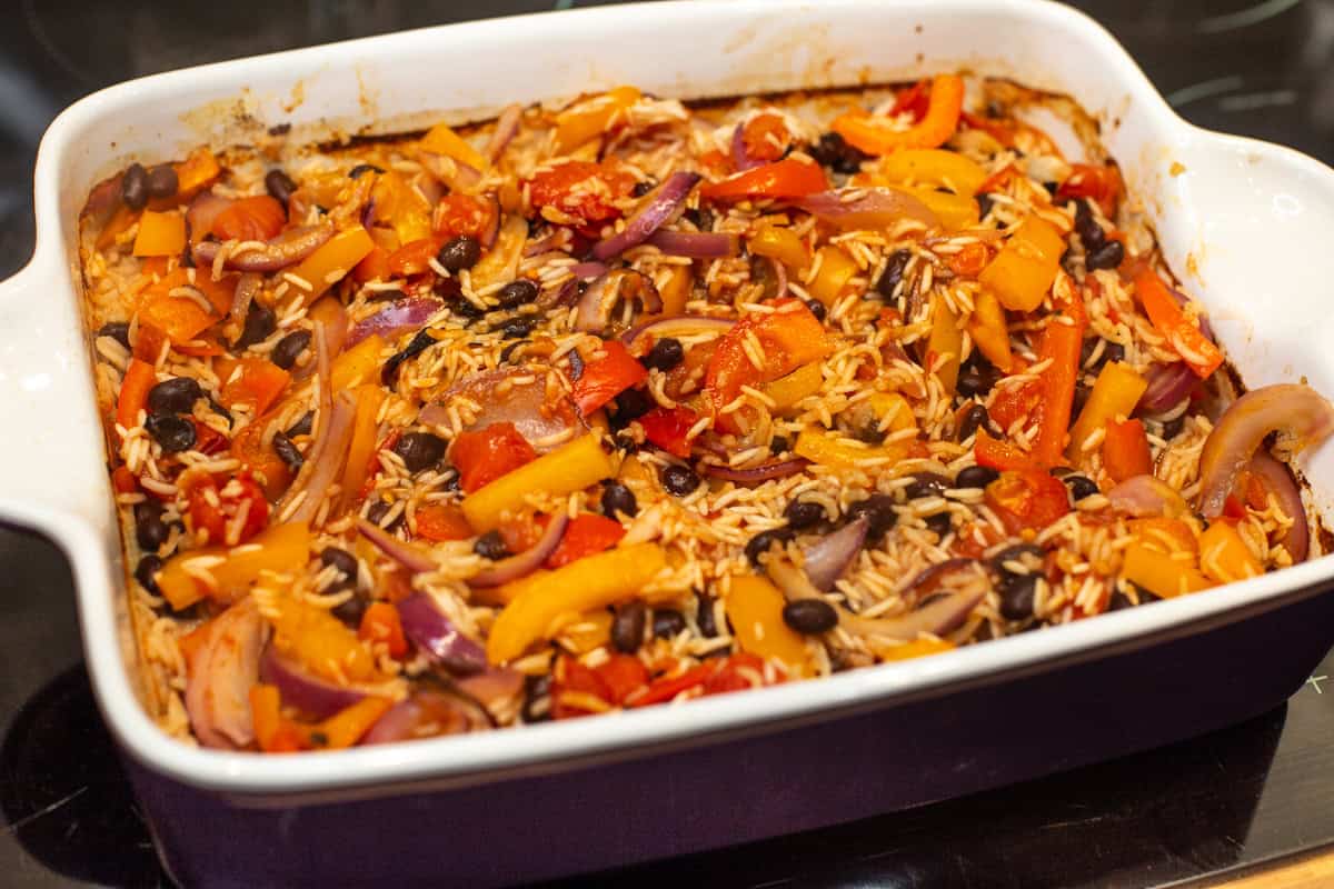 Baked rice with beans and vegetables in a large baking dish.