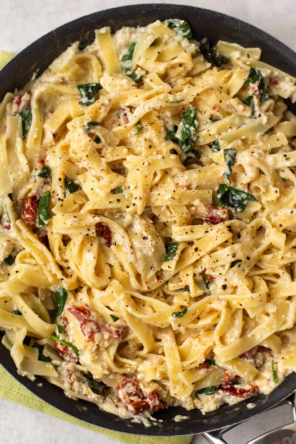 Overhead shot of a pan full of creamy tofu pasta.